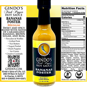 Gindo's Fresh Pepper Hot Sauce Bananas Foster bottle with label and nutrition facts on a yellow background