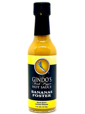 Bottle of Gindo's Bananas Foster hot sauce on a white background