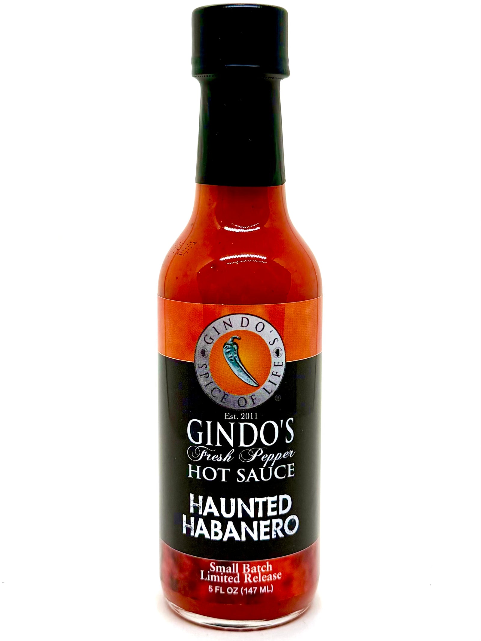 Bottle of Gindo's Haunted Habanero hot sauce on a white background