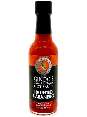 Bottle of Gindo's Haunted Habanero hot sauce on a white background