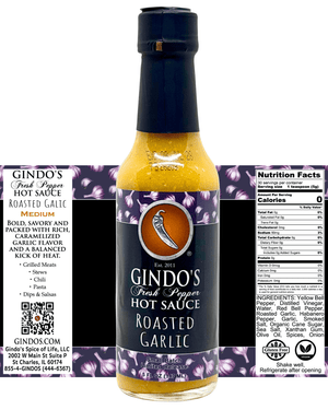 A bottle of Gindo's Fresh Pepper Roasted Garlic Hot Sauce centered on a white background, with a branded purple patterned label and a Nutrition Facts panel shown behind it.