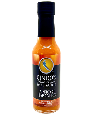 Bottle of Gindo's Apricot Habanero hot sauce on a white background