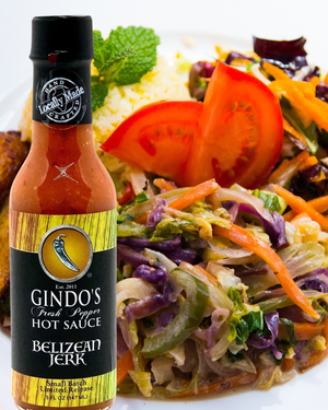 Gindo's Fresh Pepper Hot Sauce bottle with a salad in the background