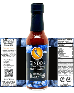A bottle of Gindo's Blueberry Habanero Hot Sauce centered on a white background, flanked by informational panels showing the brand name, flavor description, nutrition facts, and ingredients. The bottle has a dark cap and neck, reddish-brown sauce inside, and a blue label with a yellow bird logo.