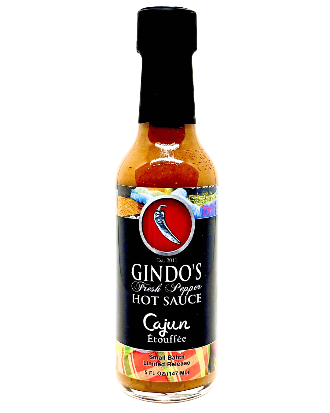 A bottle of Gindo's Fresh Pepper Hot Sauce in the Cajun Etouffee flavor, featuring a black cap and a black label with a red logo, set against a plain white background.