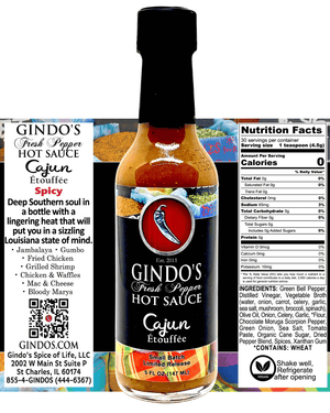 A bottle of Gindo's Fresh Pepper Cajun Etouffee hot sauce shown against a split background with product information panels on the left and right. The bottle is amber glass with a black cap and a red, black, and white label featuring a bird logo.