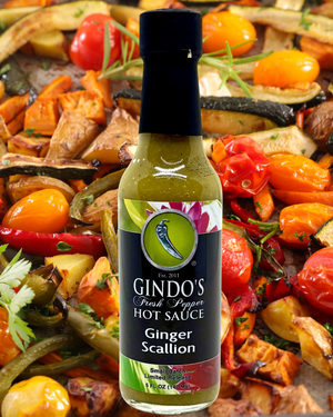 Gindo's Ginger Scallion hot sauce bottle with roasted vegetables in the background