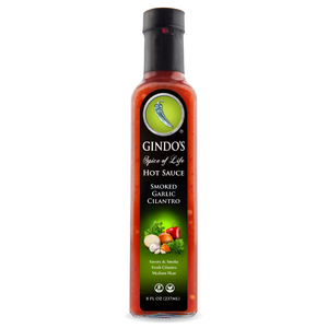 Bottle of Gindo's Smoked Garlic Cilantro Hot Sauce on a white background